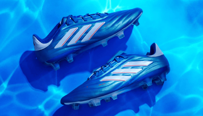 Chuteira de Campo Adidas Copa Pure 2+ FG em Lucid Blue/White/Solar Red - Toque puro e controle preciso para sua melhor performance no futebol.